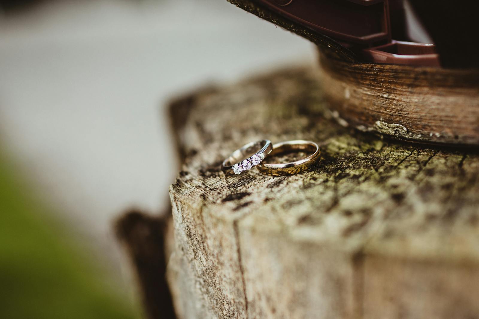 Detail shot of floral arrangements and wedding rings in soft natural light